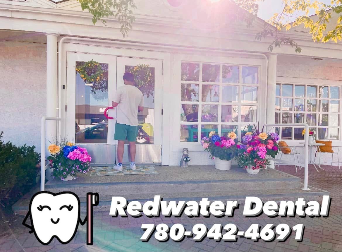 Clinic exterior with flowers in bloom — summer at Redwater Dental