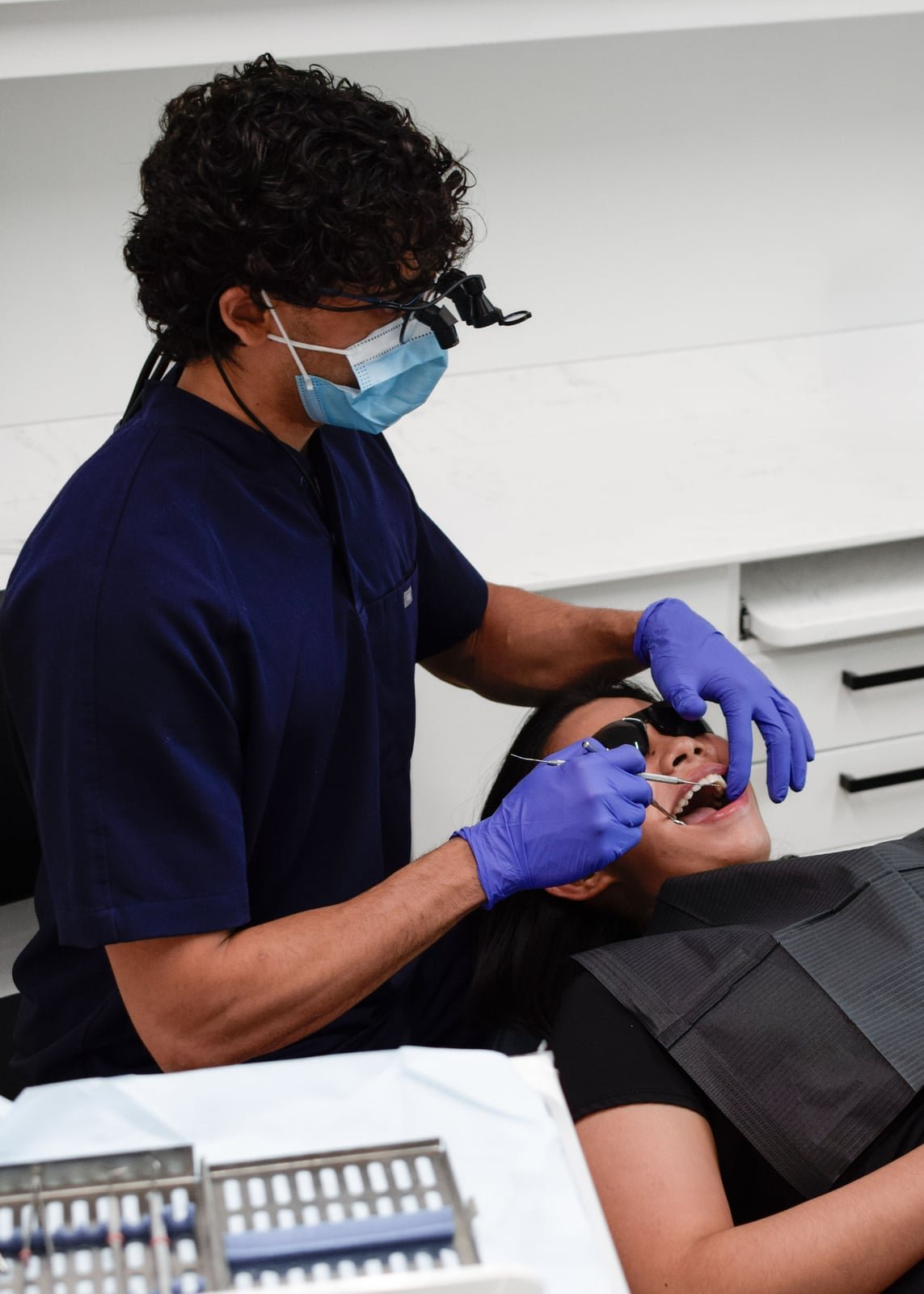 Dr. Zee chairside delivering restorative dentistry at Redwater Dental Clinic
